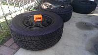 (4) four lug wheels painted black with tires-245-60-15-kelly-tires-lug-nuts-in-box.jpg