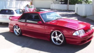 Fox Body Mustang on 20-inch rims.