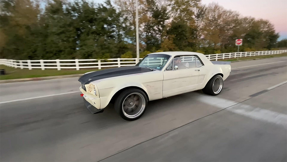 1965 Mustang Coupe with Coyote V8 driving down the road